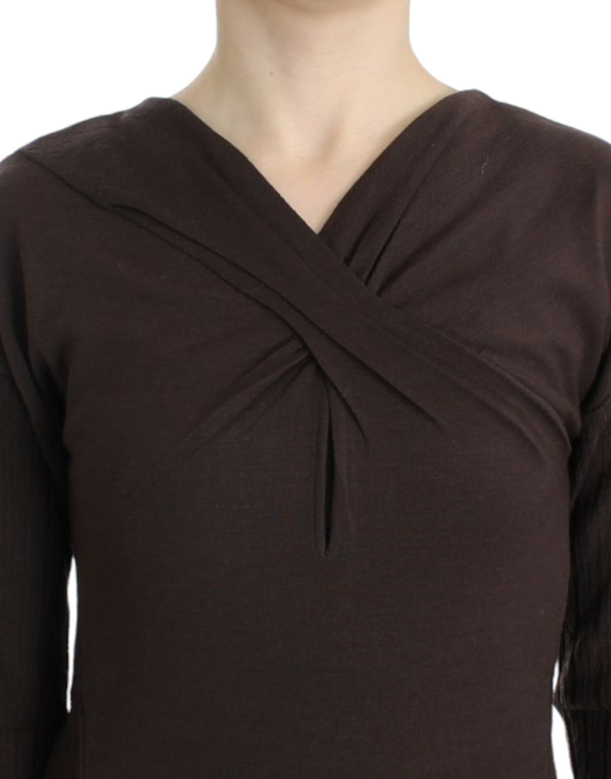 Woman wearing a brown knit top with a tie at the neckline