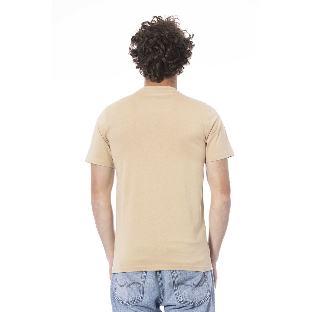 Man wearing tan t-shirt and blue jeans