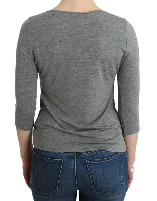 Long sleeve gray shirt on a person wearing blue jeans