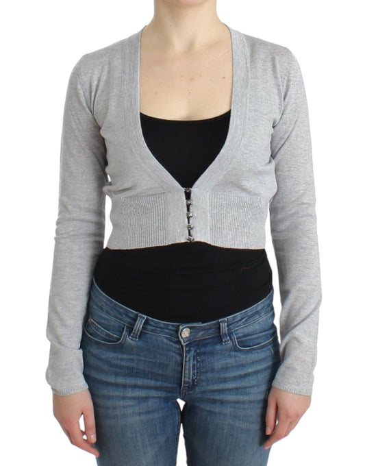 Woman wearing gray sweater vest over black tank top