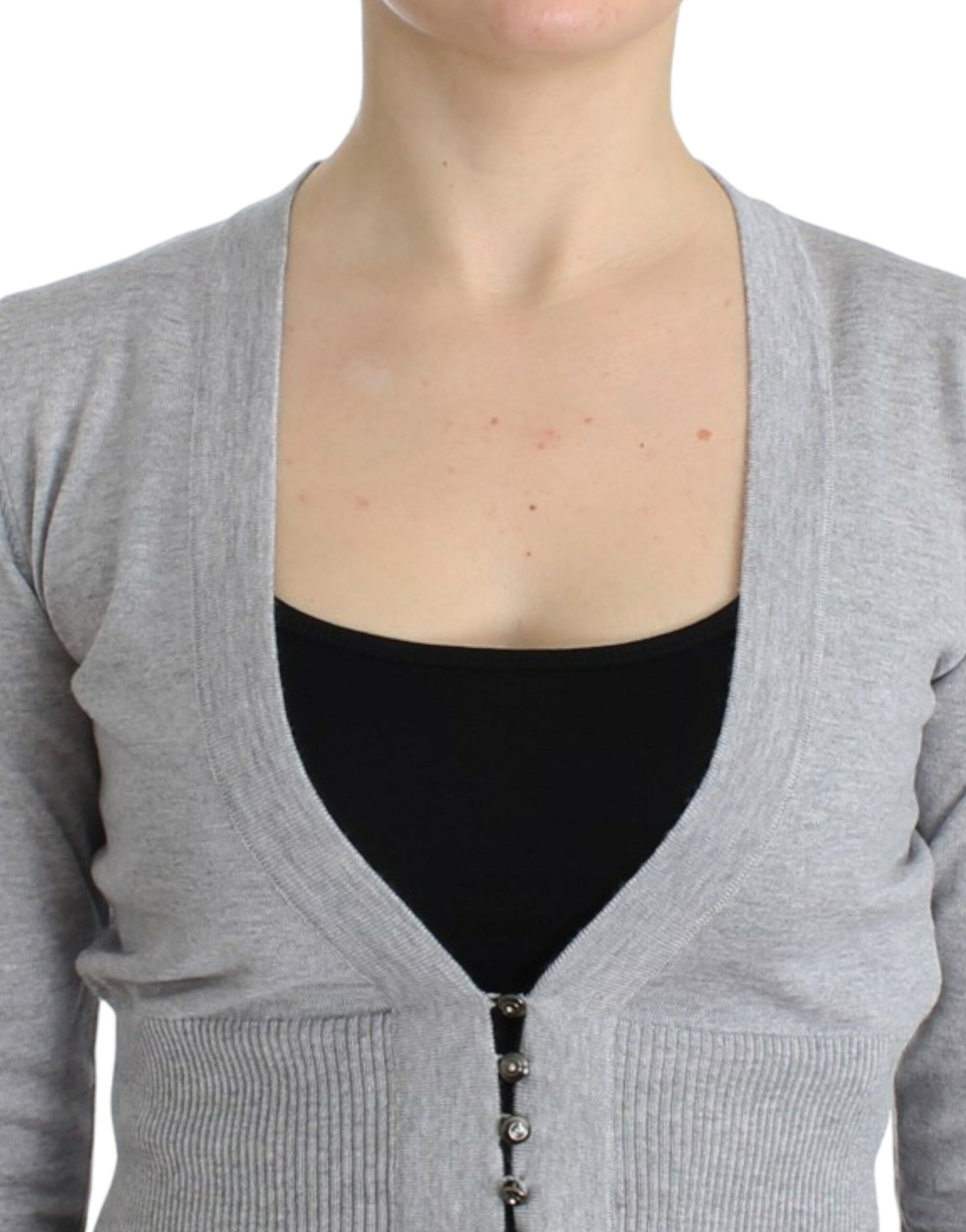 Woman wearing a gray cardigan over black top