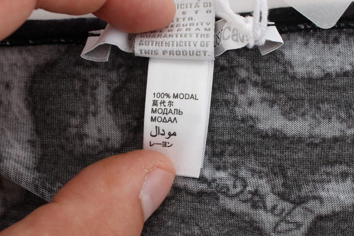 Hand holding a tag on a piece of clothing