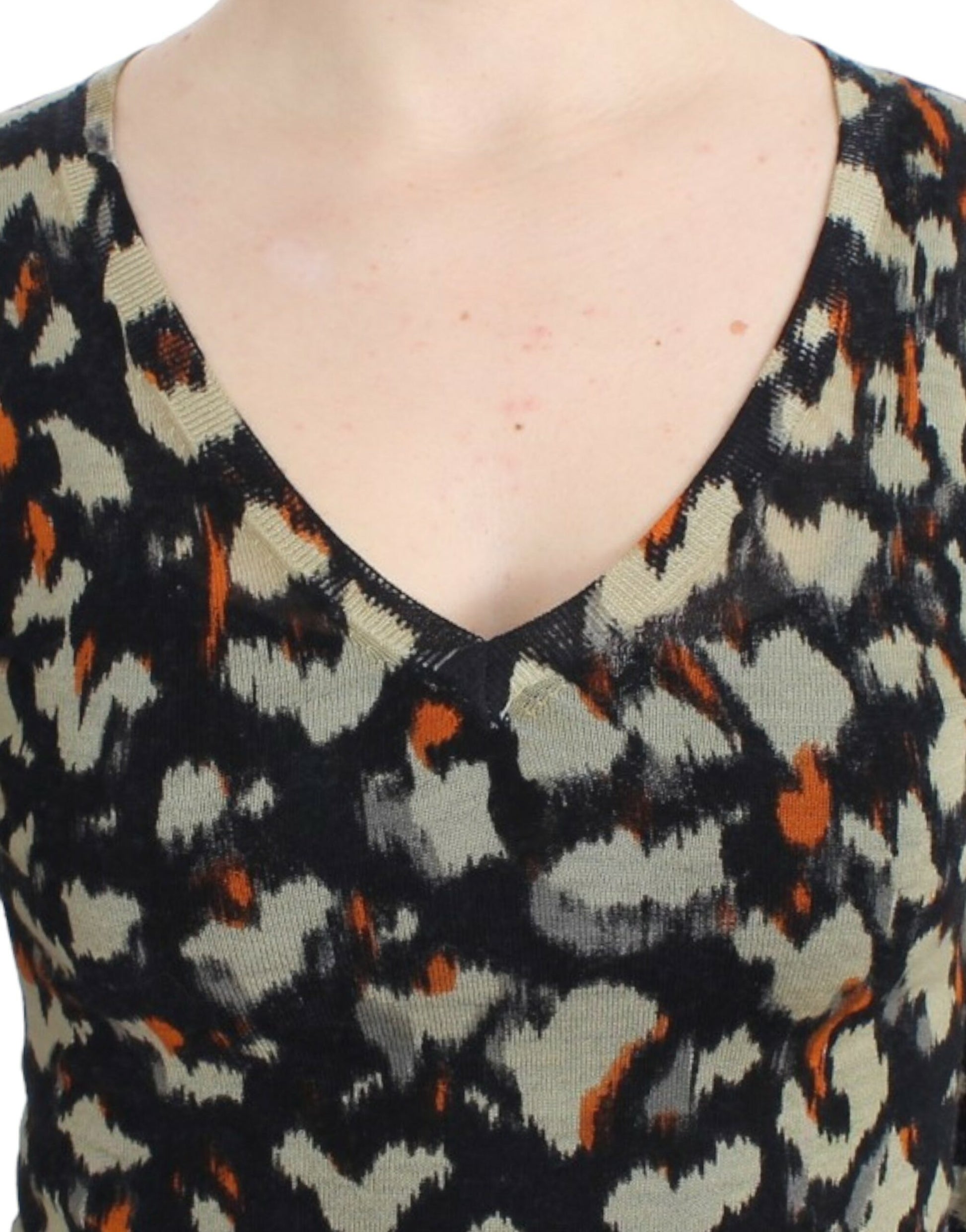 Woman wearing a black and orange patterned sweater
