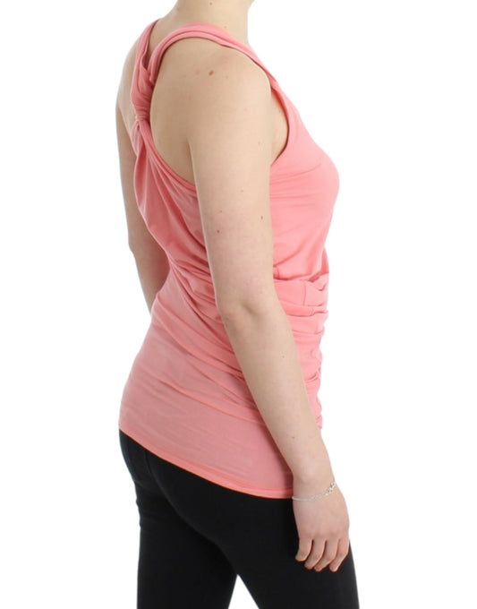 Woman wearing pink tank top and black leggings