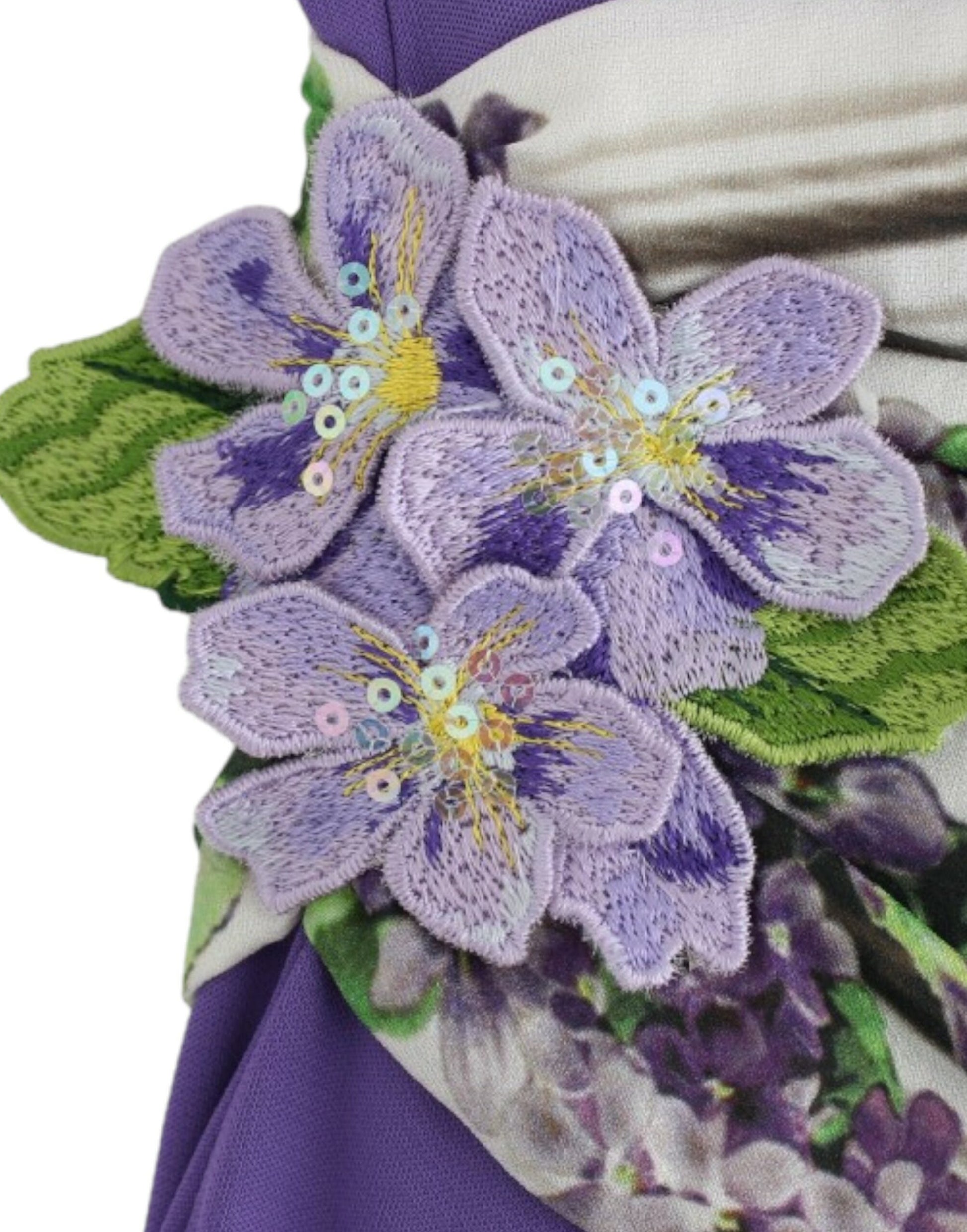 A purple flower embellishment on a dress