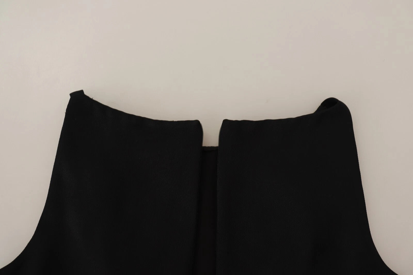 A black sleeveless pleated aline knee length dress