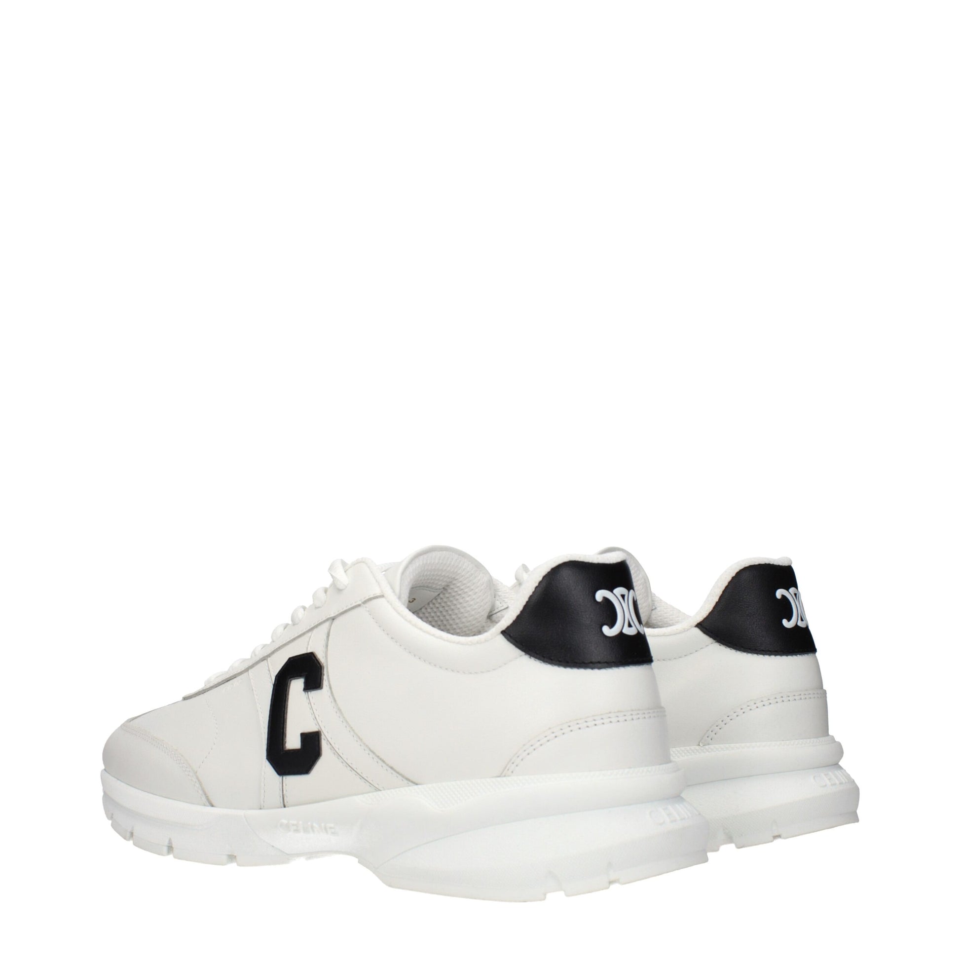 White leather athletic sneakers with black laces, logo on side, and textured sole