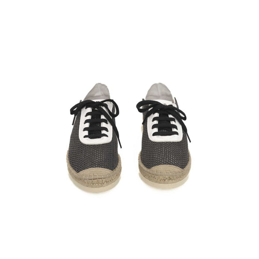 Pair of black sneakers with white laces, featuring a calfskin upper and a rubber sole