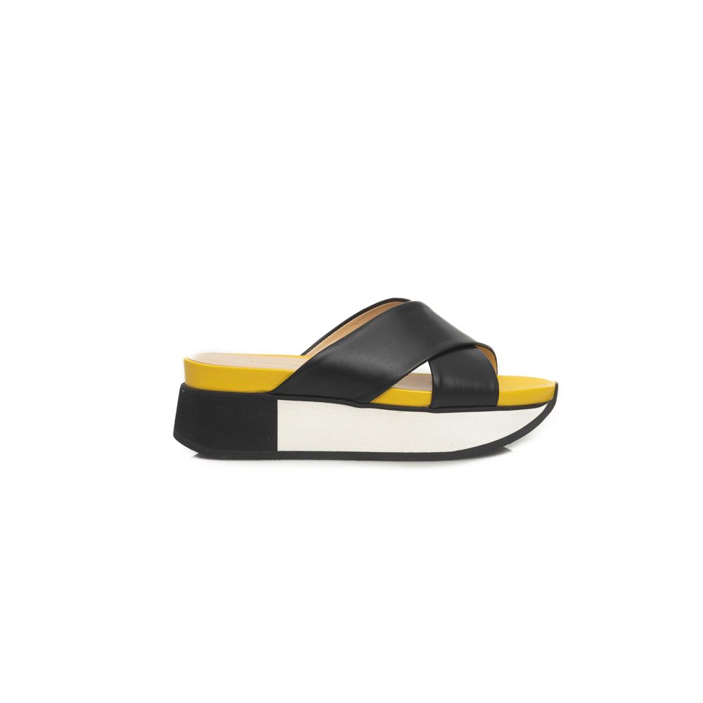Yellow and black sandal with strap over foot