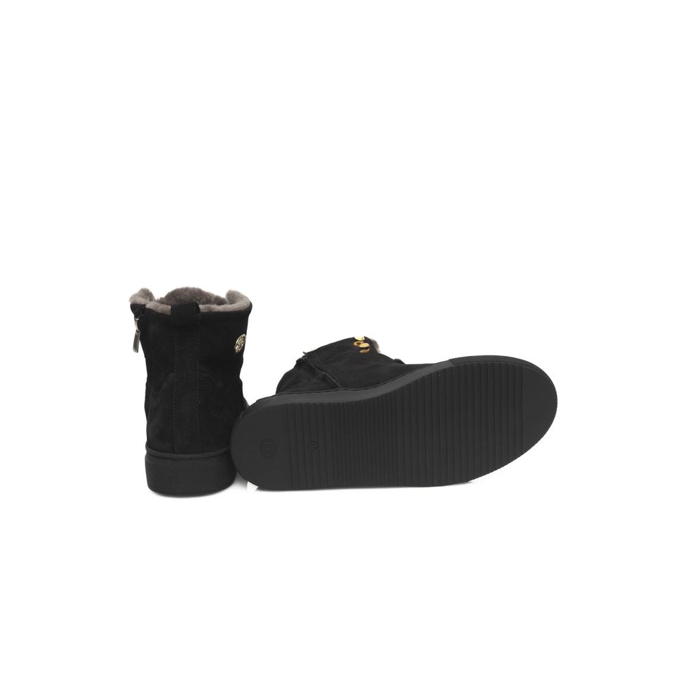 A pair of black women's sneakers with a cowhide texture and gold accents