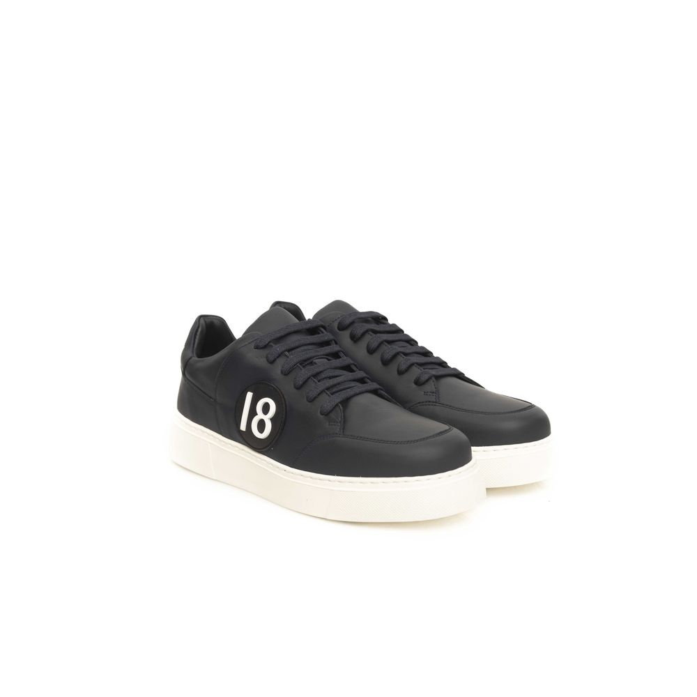 Black sneakers with white sole, featuring a cowhide texture on upper and a white logo on side