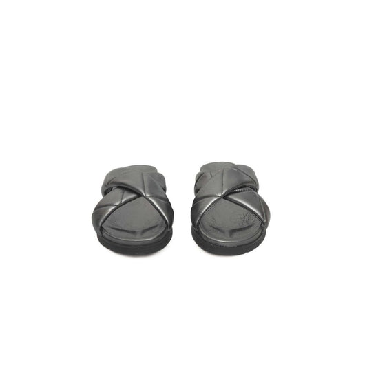 Pair of black slippers with a strap across the top