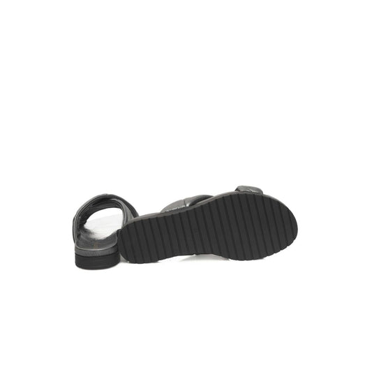 Pair of black flip flops with white soles