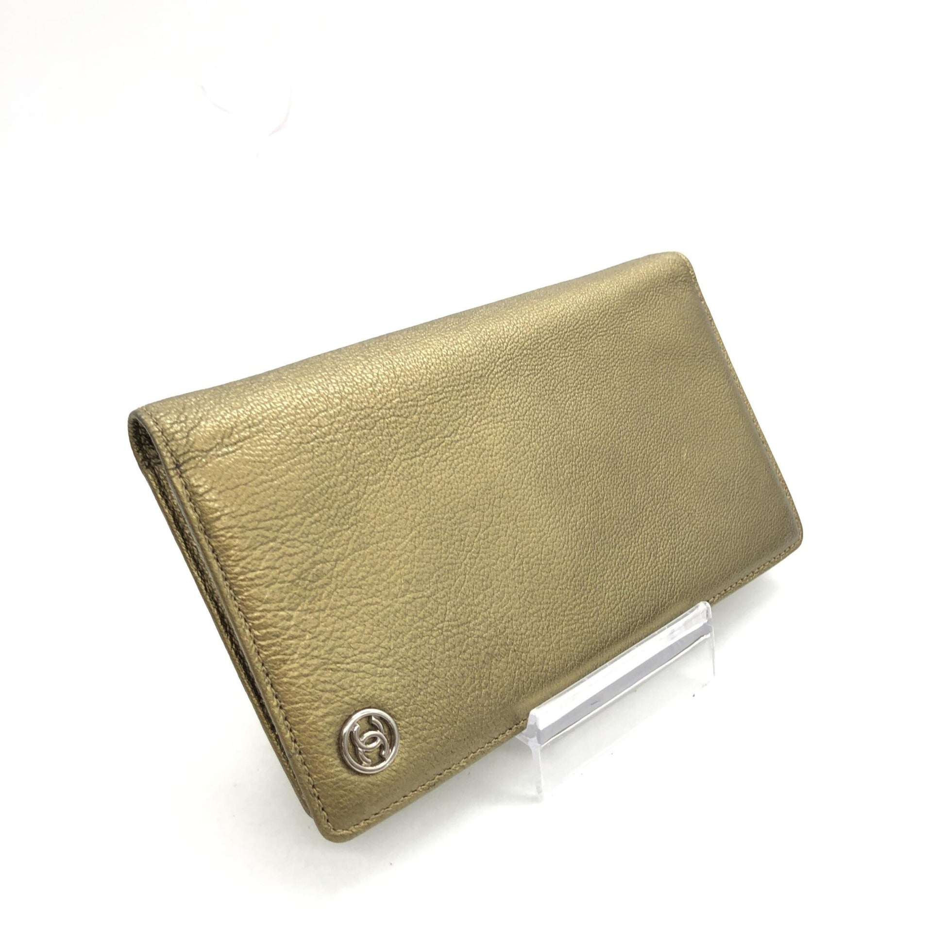 Gold leather wallet on display stand