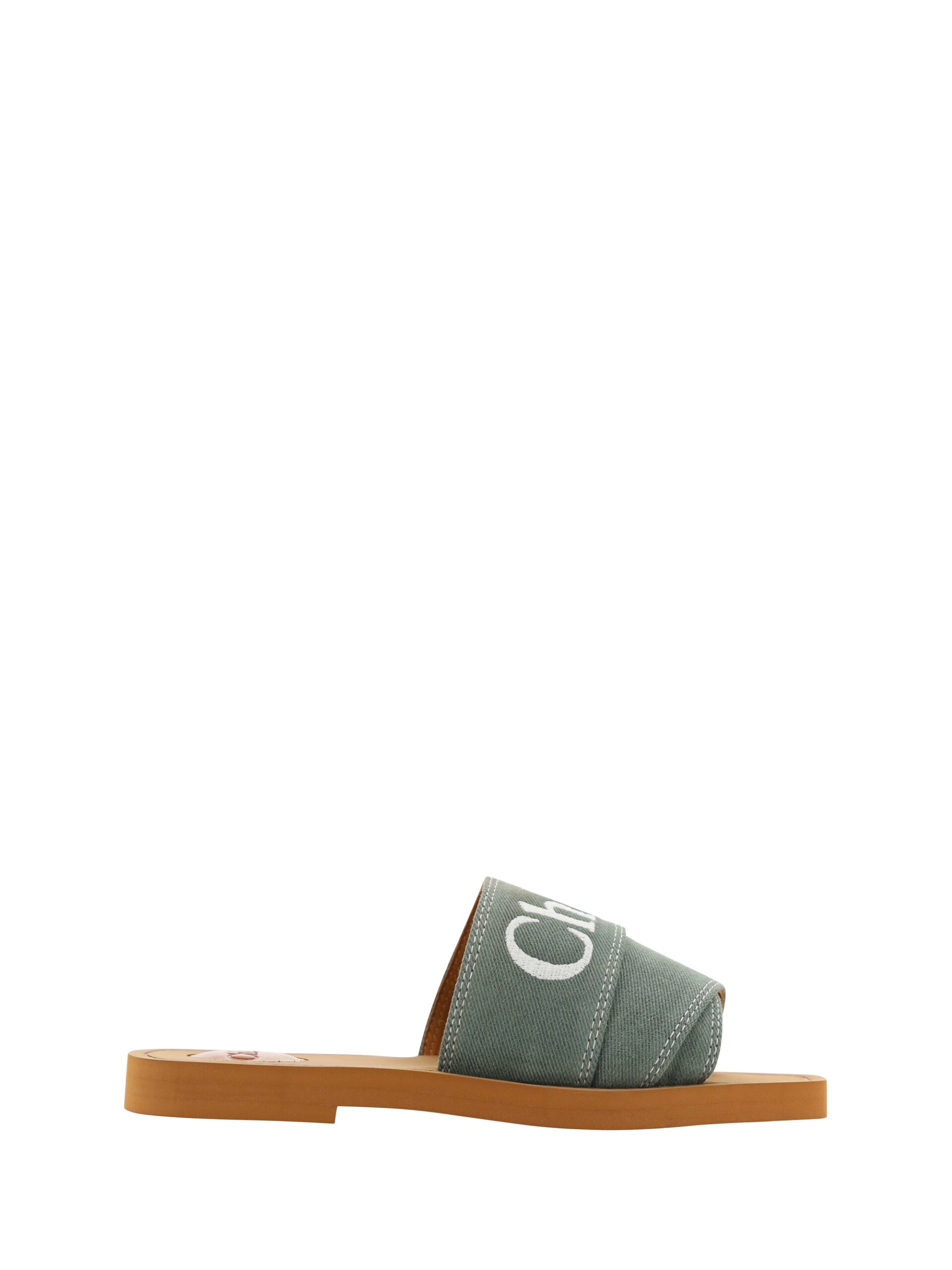 Pair of sandals with green straps and brown soles