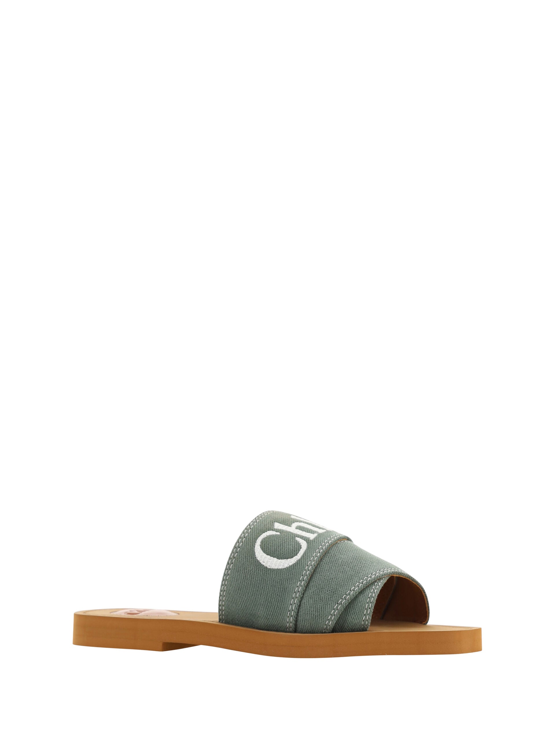 Green and brown sandal with strap over foot