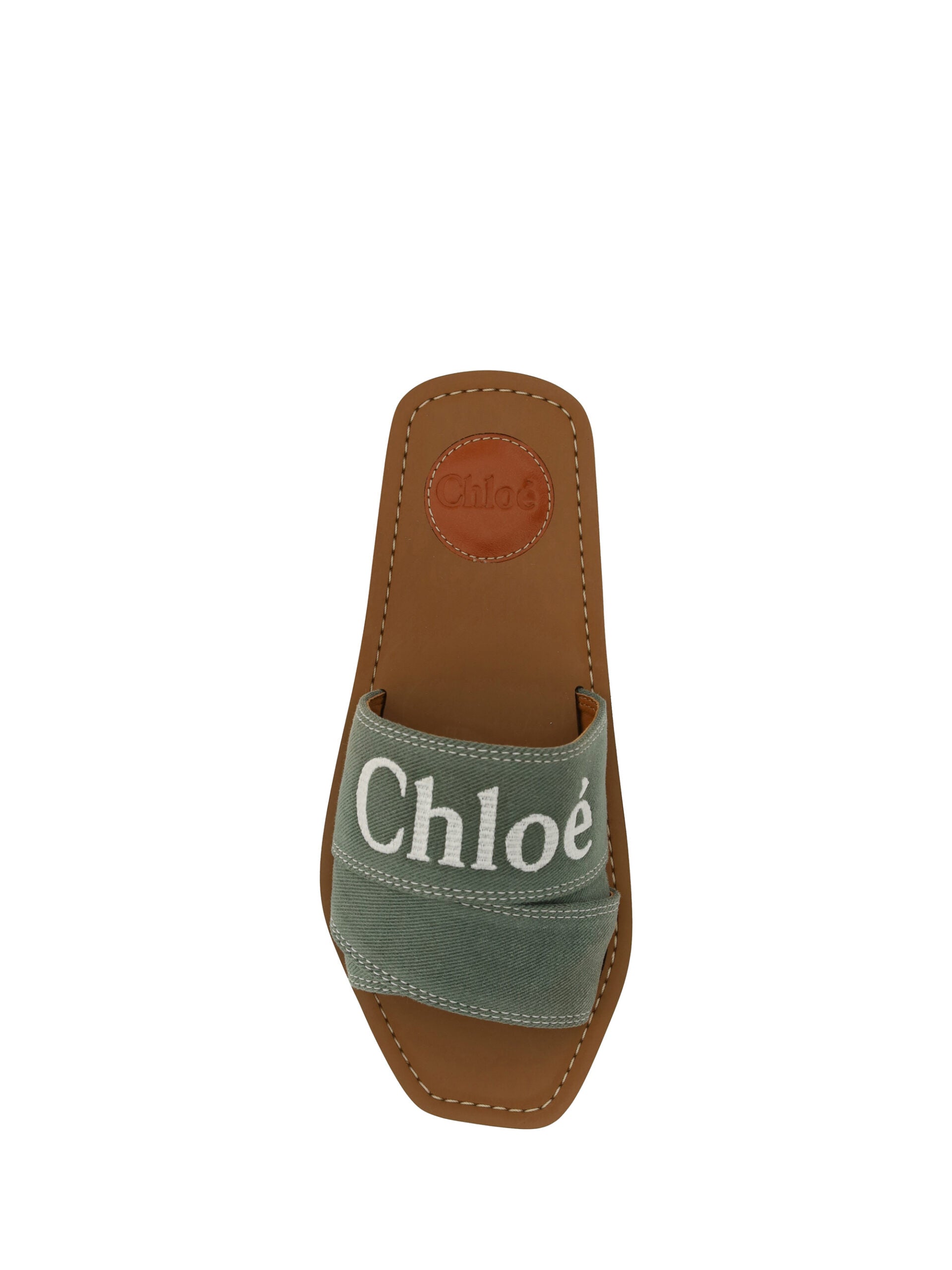 Brown sandal with strap over foot and ankle