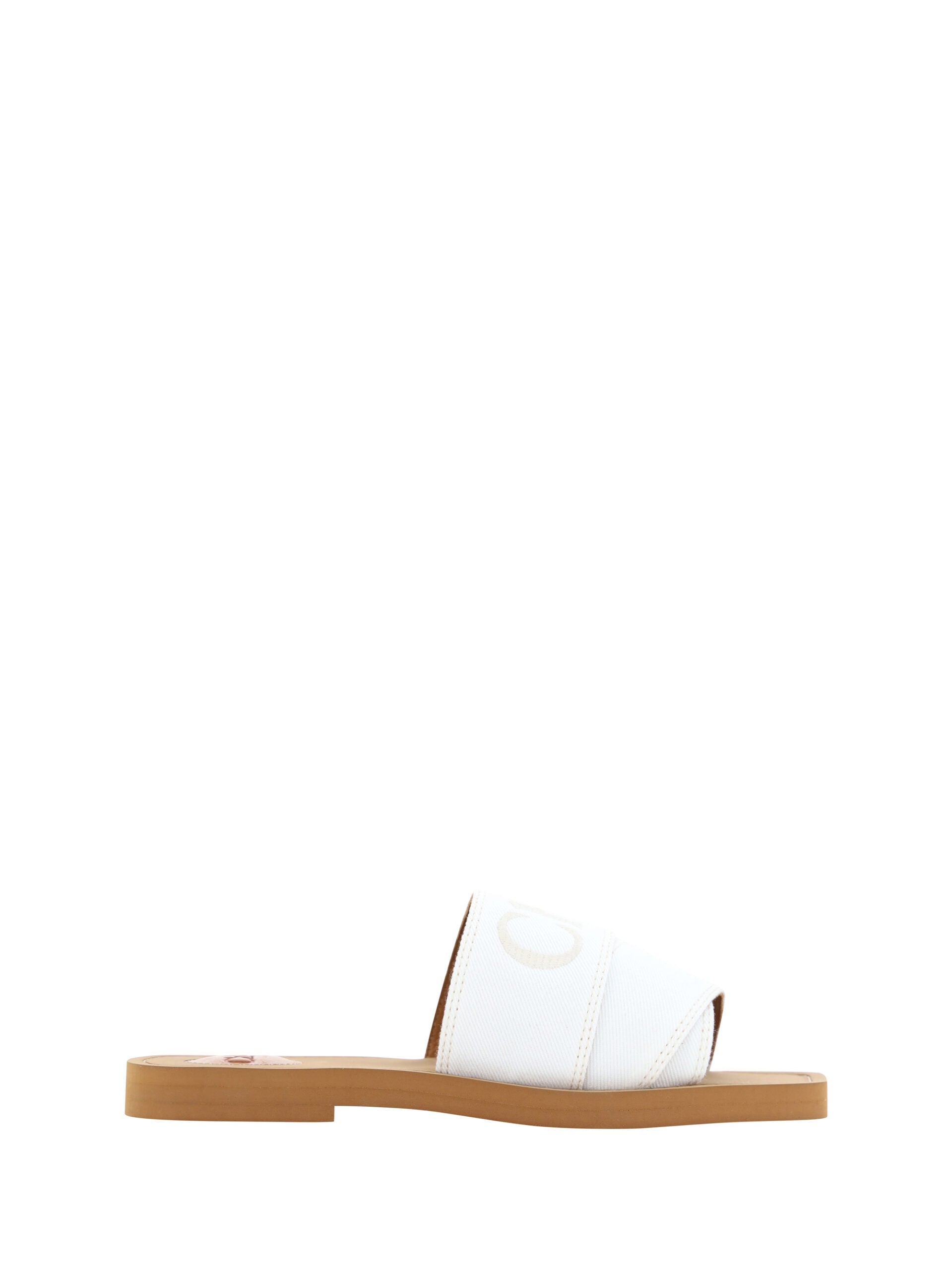 Pair of white sandals with brown soles and straps