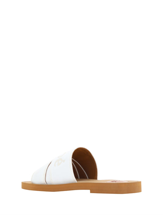 Pair of brown sandals with white soles and straps