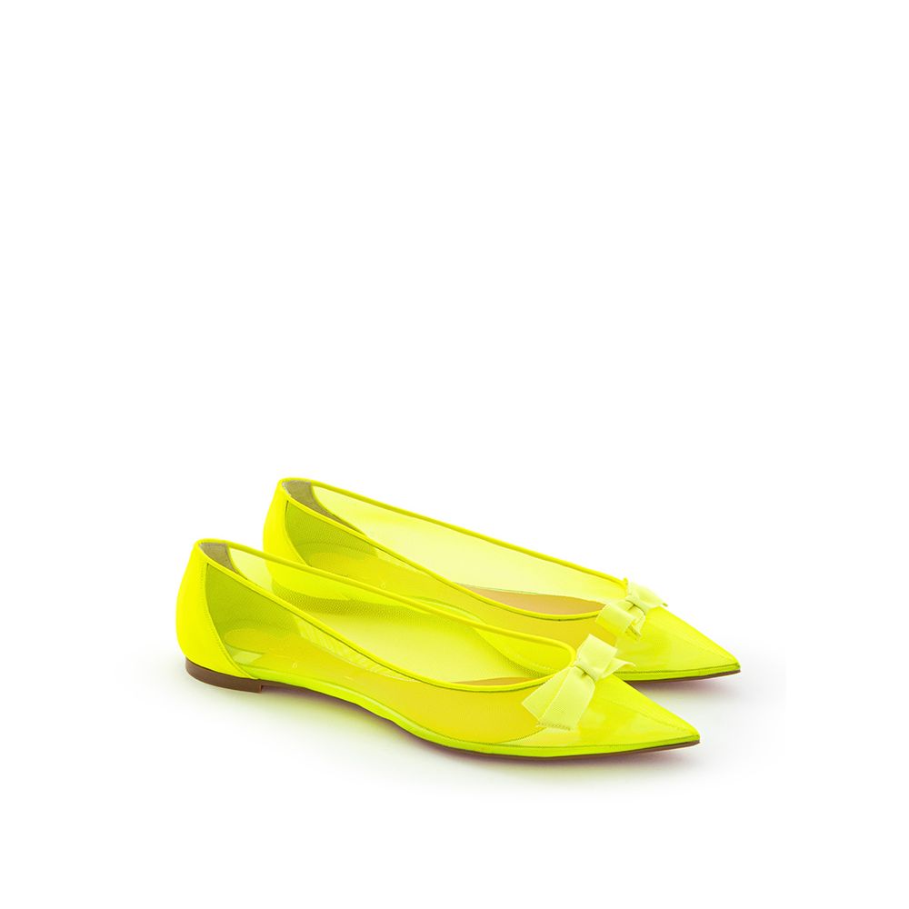 Yellow high heel shoes with bow on top of foot