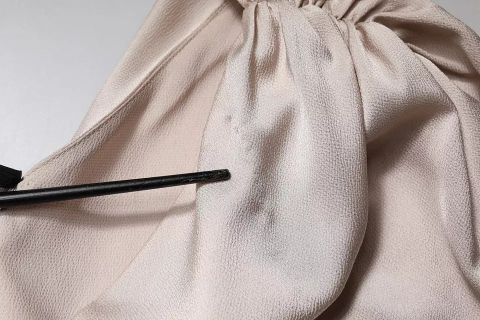 Pink satin fabric with black ribbon tied in a bow