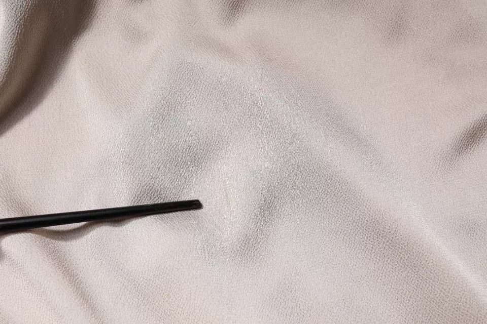 Black metal pipe on bed
