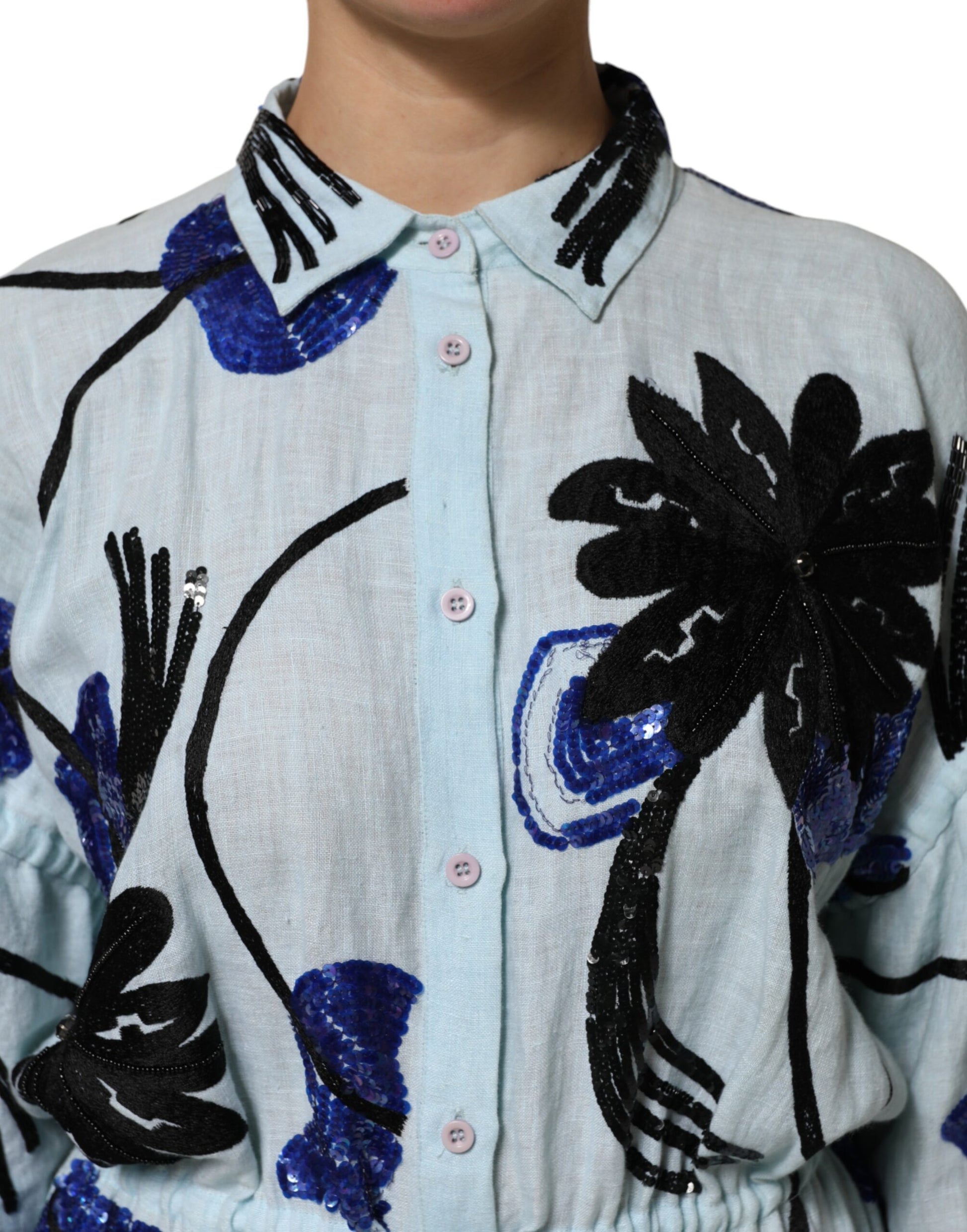 A blue sequin embellished shirt maxi dress with a tropical leaf pattern