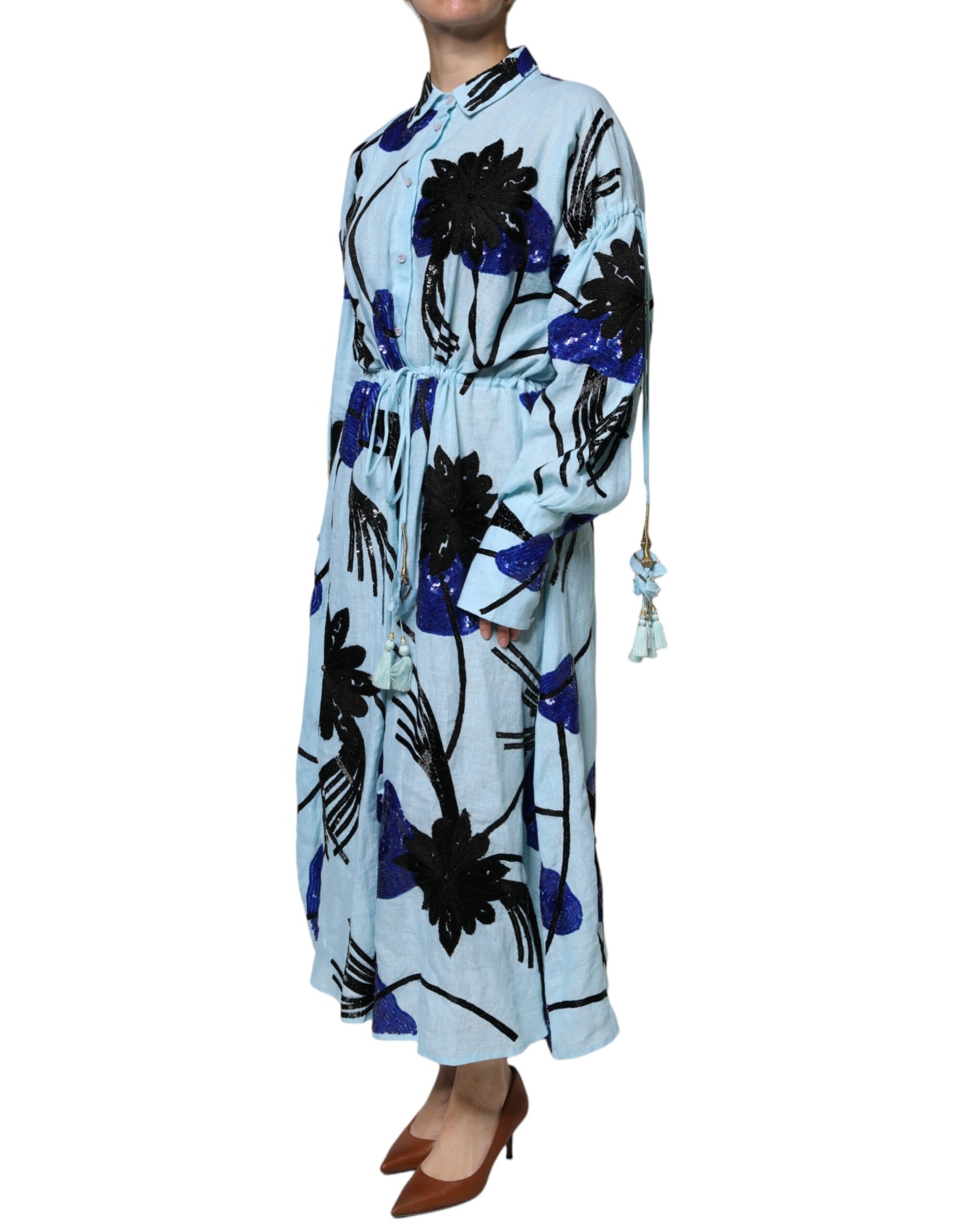 A long blue dress with floral embroidery and beaded details