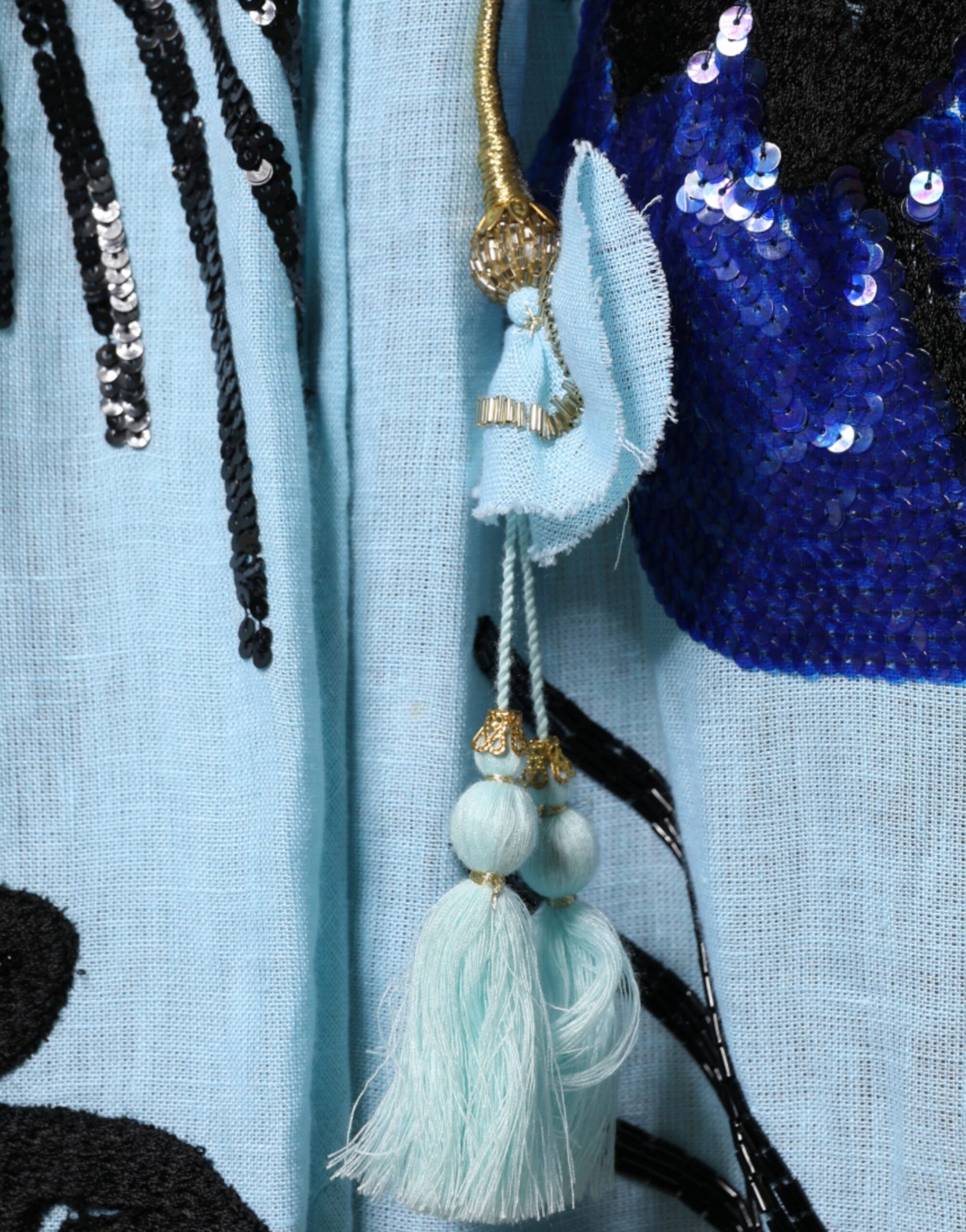 A light blue floral embellished maxi dress with a tassel detail