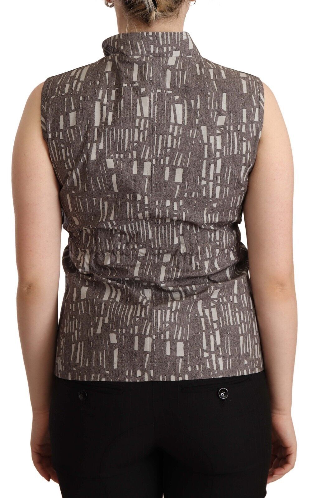 Back view of a woman wearing a sleeveless vest with a patterned design