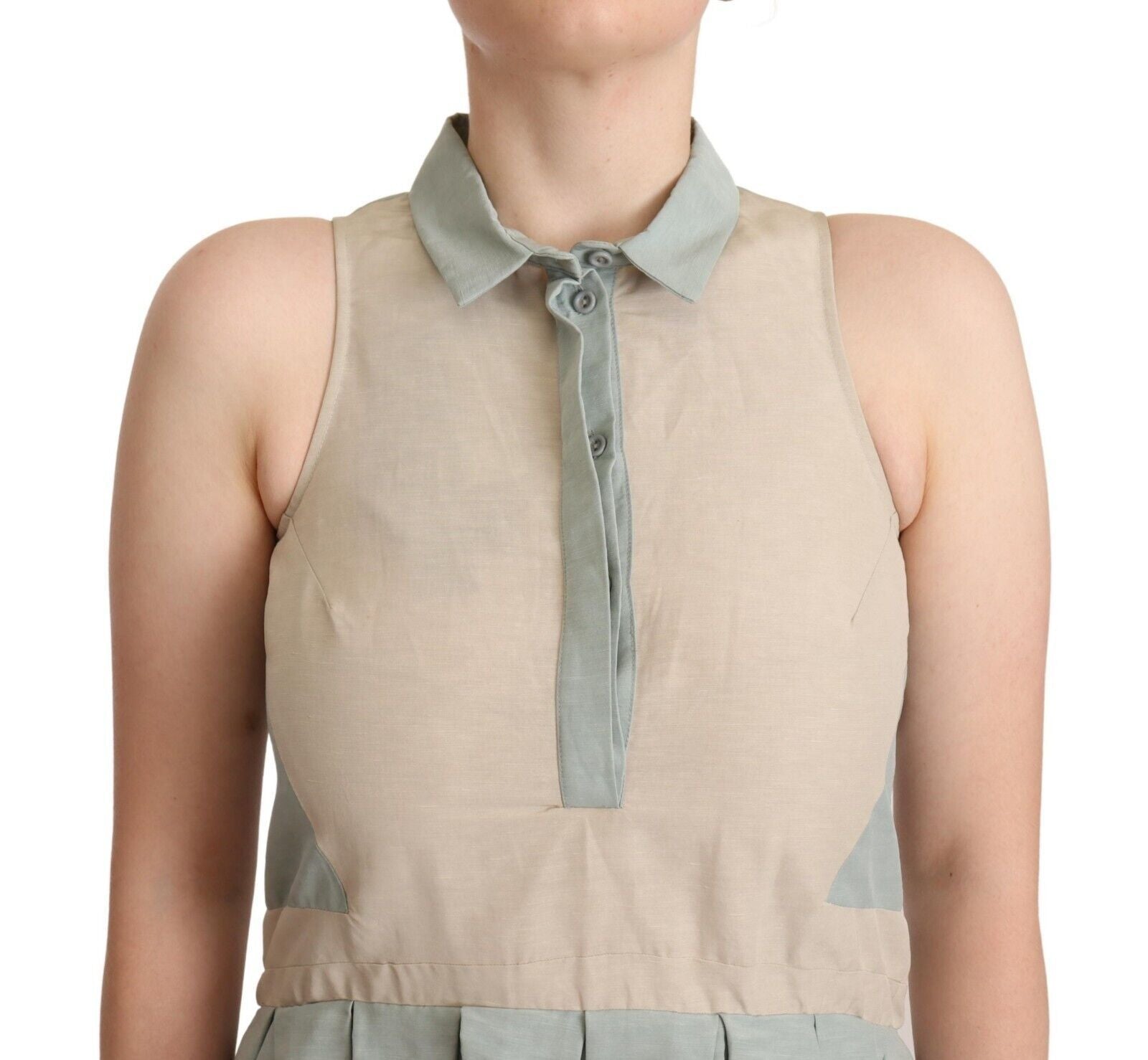 A sleeveless sheath dress with a collar and a tie at the neck