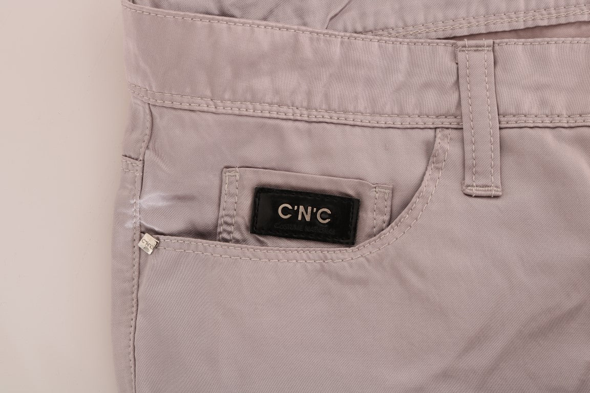 Pair of light pink jeans with a small black tag on the left side pocket