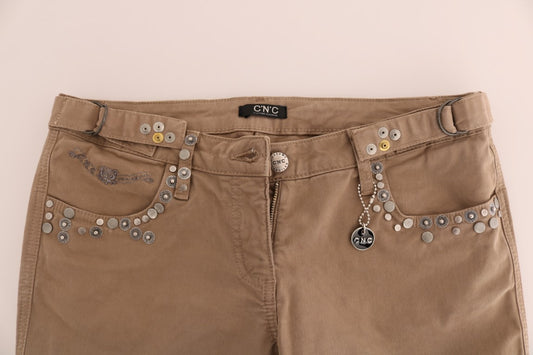 Brown denim jeans with embellishments on front pockets