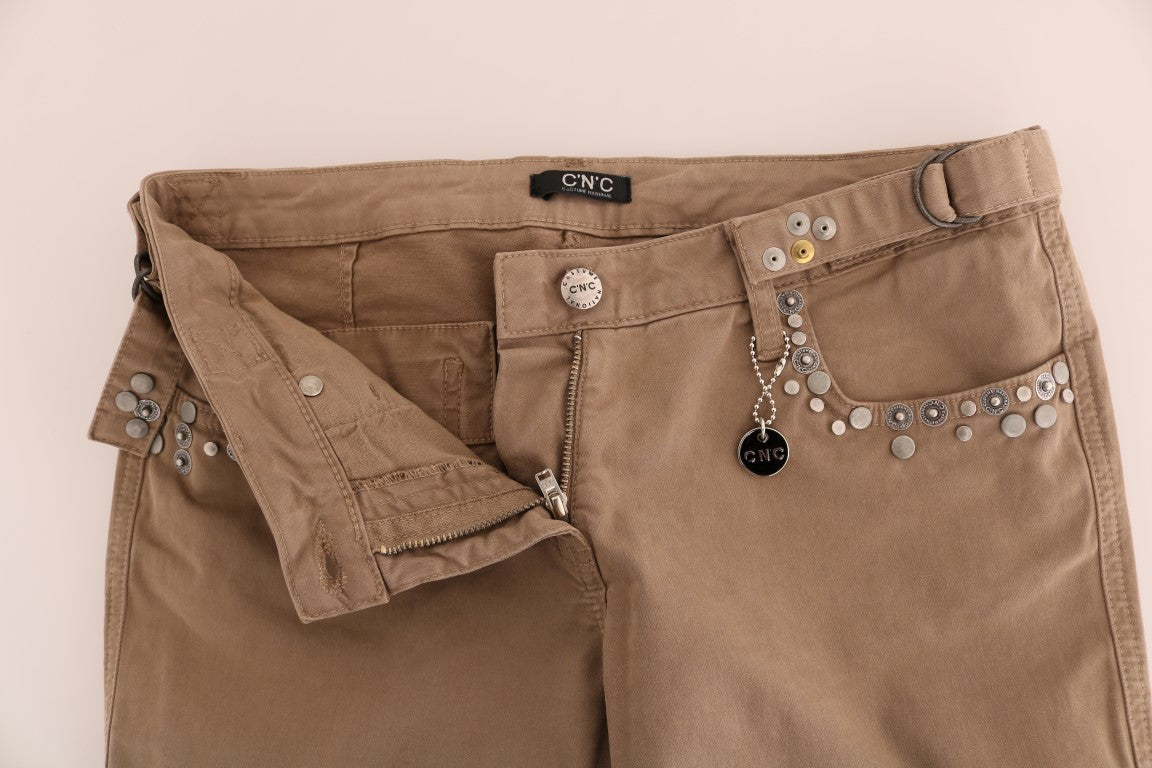Brown jeans with decorative studs on front pockets