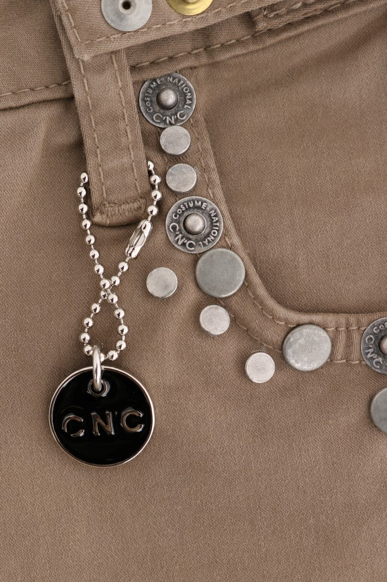 Silver charm necklace with round silver charms and a black tag that says "CNC"