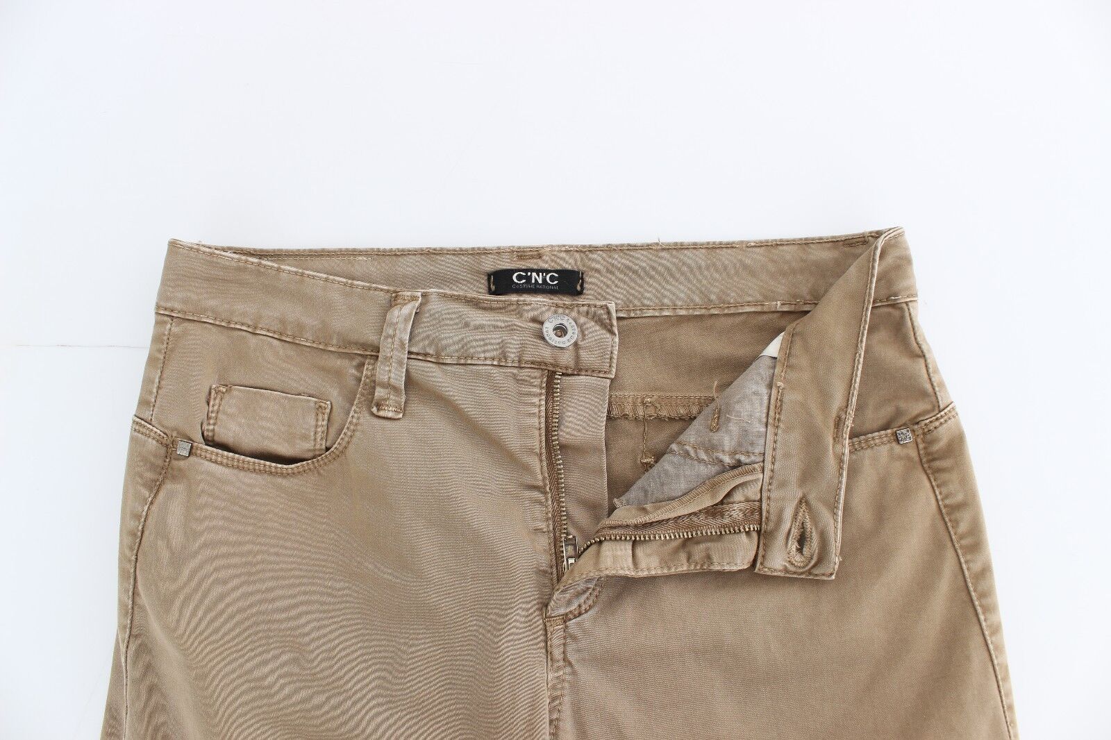 Pair of light brown women's jeans with a small hole in the right knee area