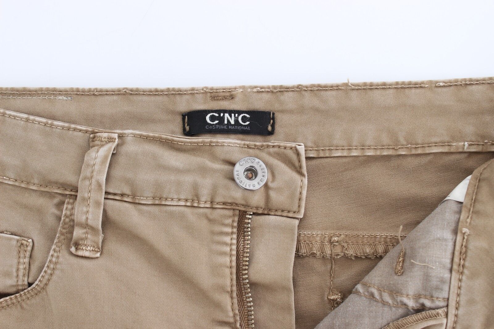 Pair of light brown denim jeans with visible brand label on waistband
