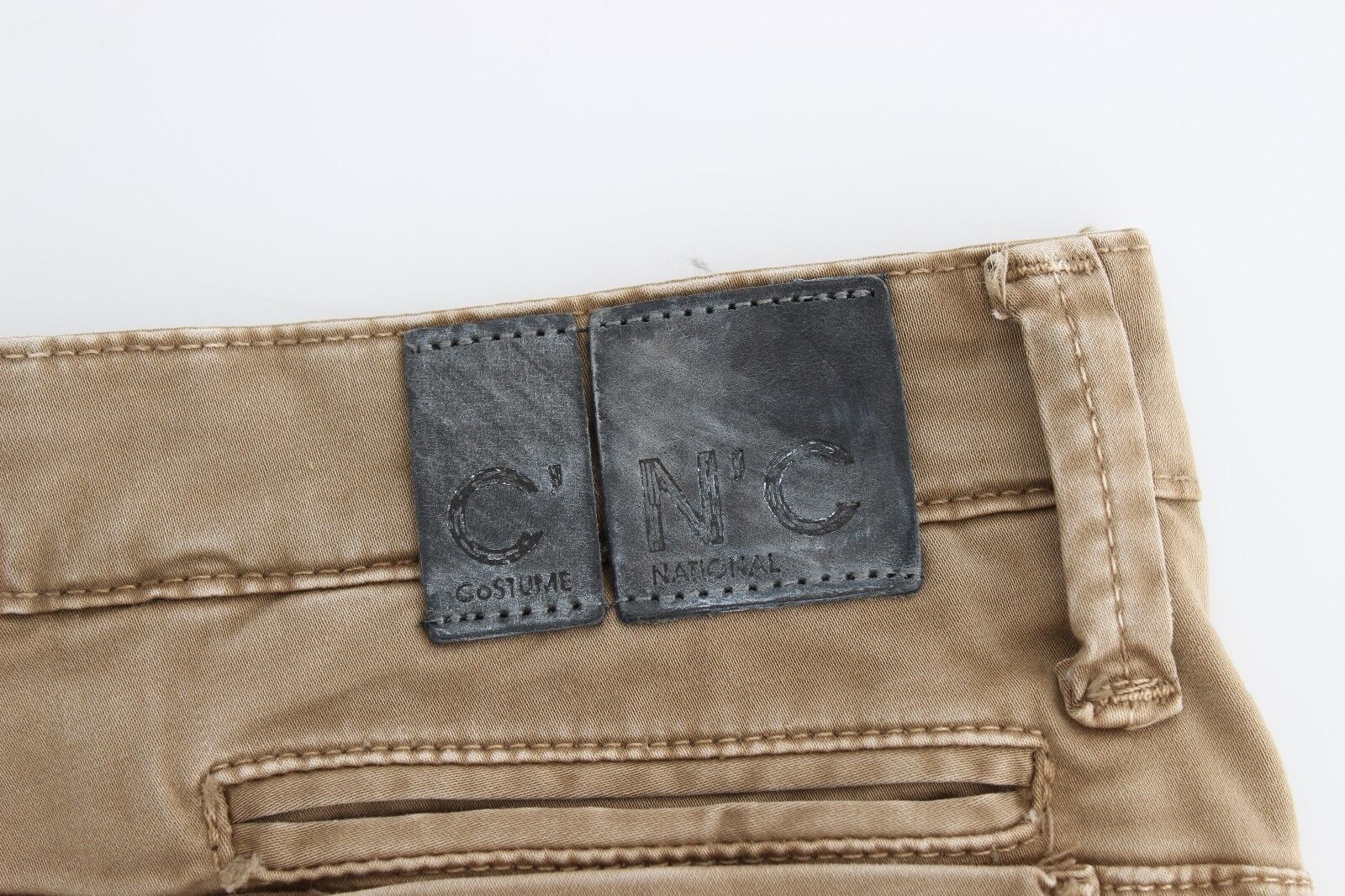 Pair of brown jeans with black buttons