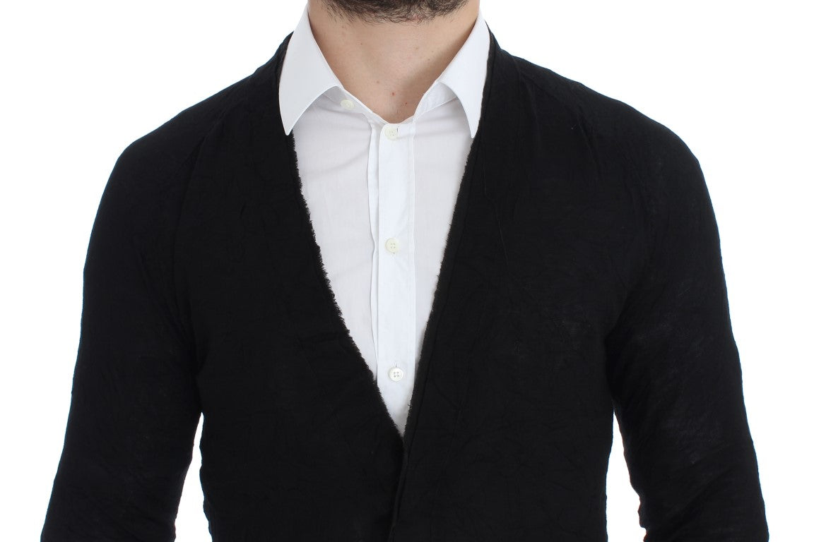 Man wearing black sweater vest over white shirt