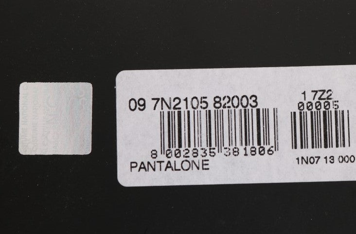 White label on black background with barcode and product information