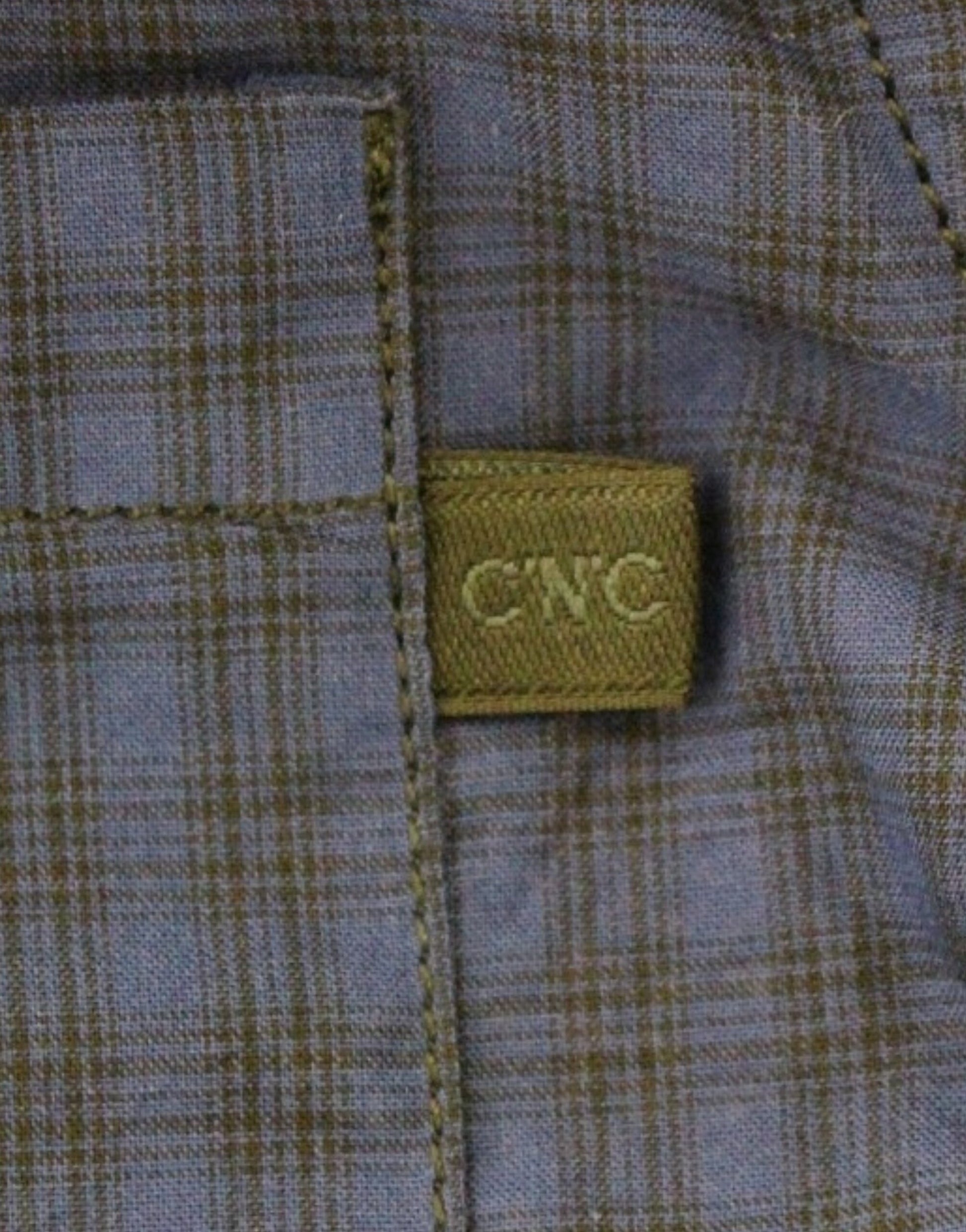 Blue plaid shirt with a label on the sleeve