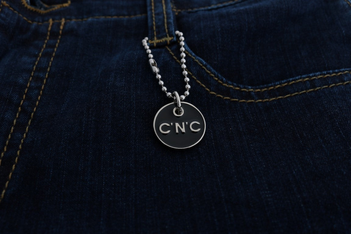 Silver necklace with a round pendant featuring the letters "CNC" in black