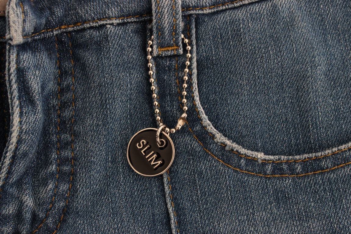 Silver charm on blue jeans