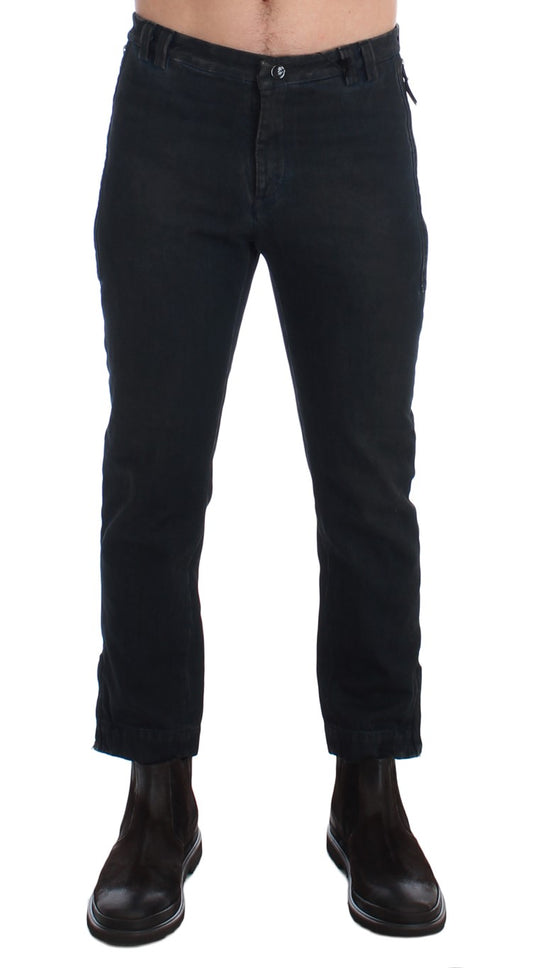Pair of black jeans with rolled up legs and a zipper fly
