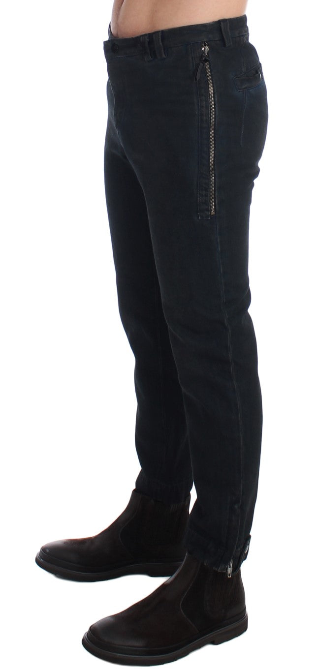 Pair of dark blue jeans with zipper detailing on front and back pockets