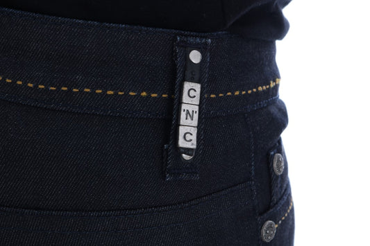 Blue denim jeans with yellow stitching on waistband