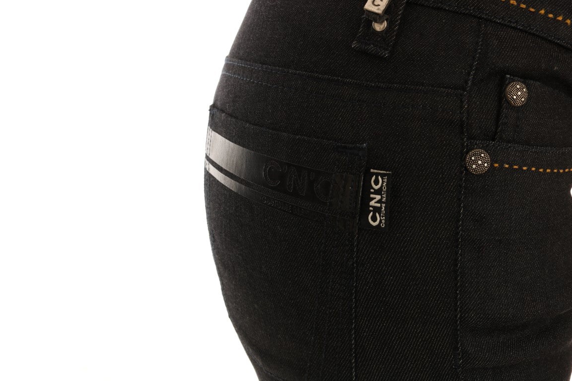 Pair of dark blue jeans with visible stitching and brand logo on waistband