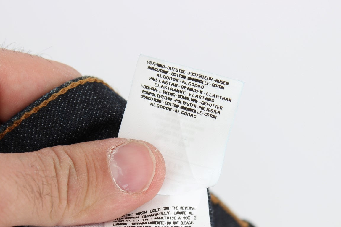 Hand holding a tag on a piece of clothing