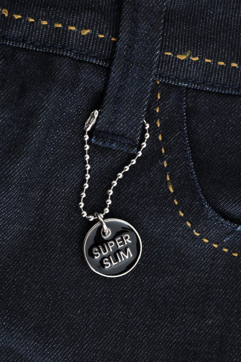 Silver necklace with a round pendant that says "super slim" on it