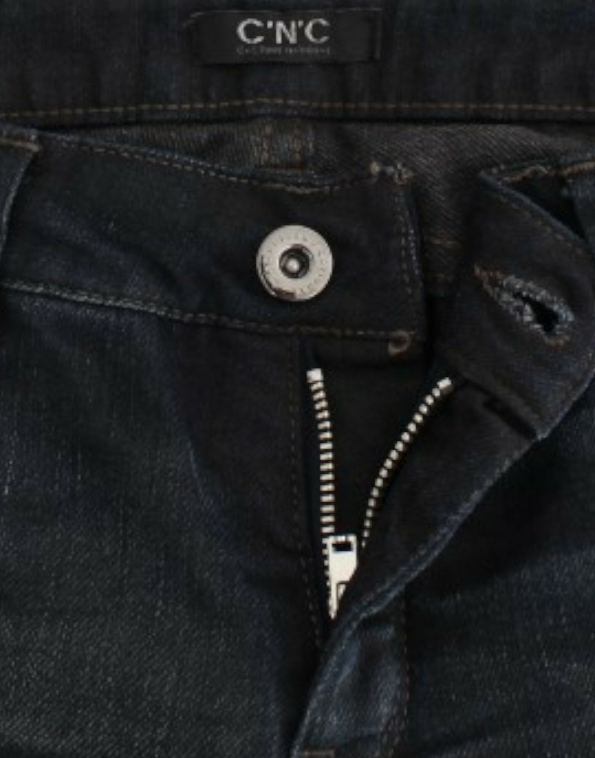 Pair of blue jeans with zipper and button closure